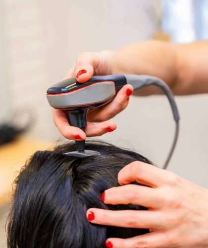 Woman receiving hair loss treatment at capillary clinic